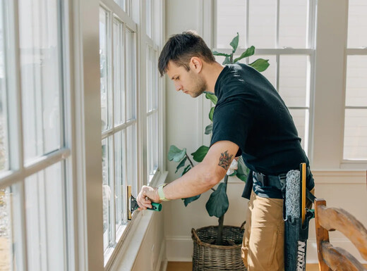 Taylor carefully cleaning interior windows